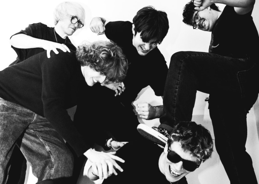 Dylan Winters & The Posterity members pretending to stamp on one of the other membersx